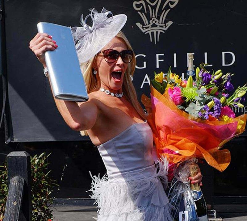 A lady celebrates after winning a prize.
