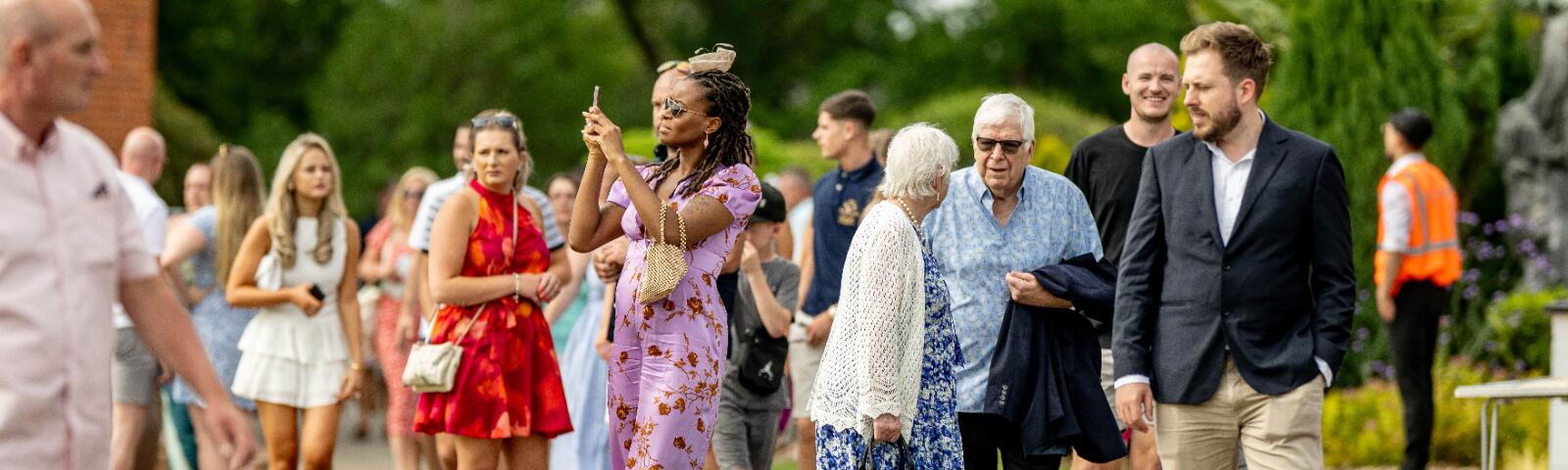 Race goers enter Lingfield Park for a race day