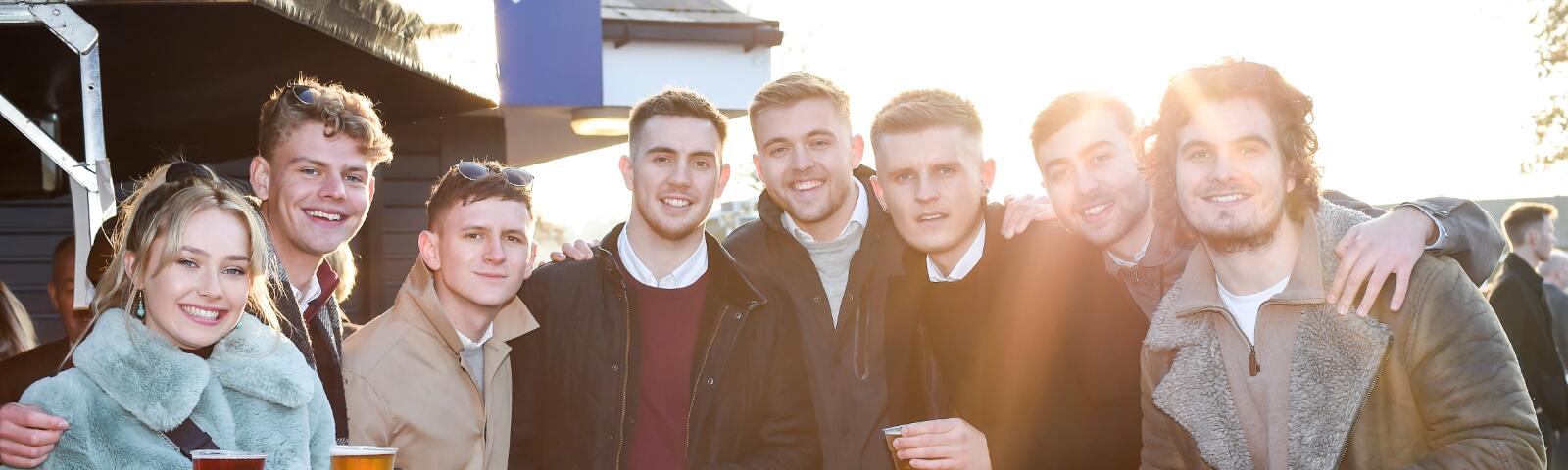 A large group of friends enjoy the races at Lingfield Park
