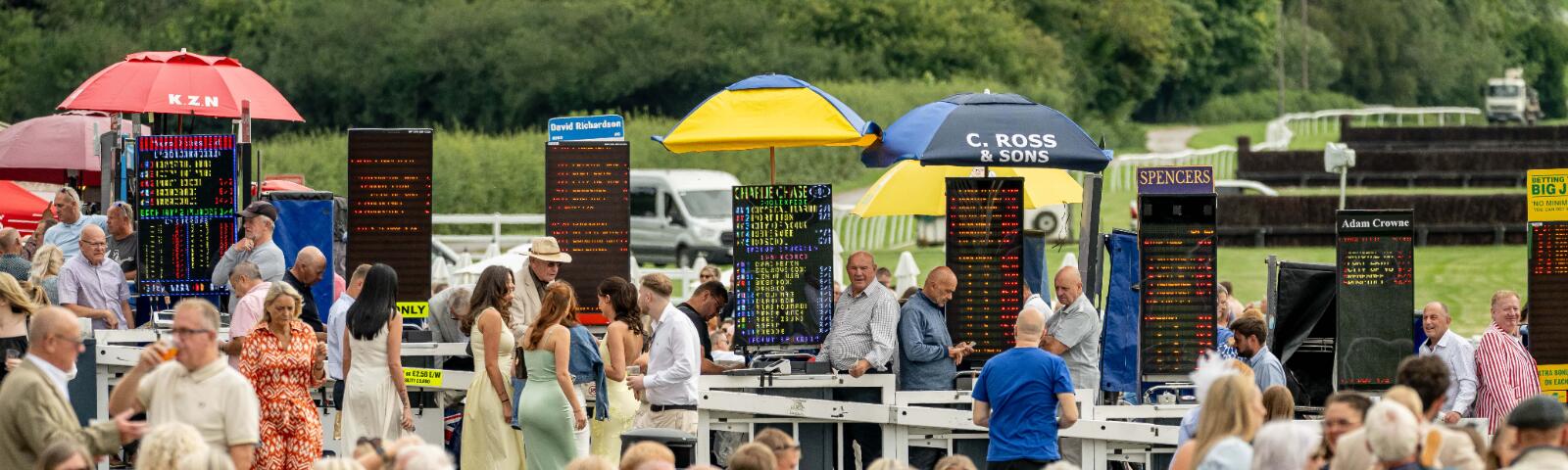 A line of betting boards showing odds at Lingfield Park