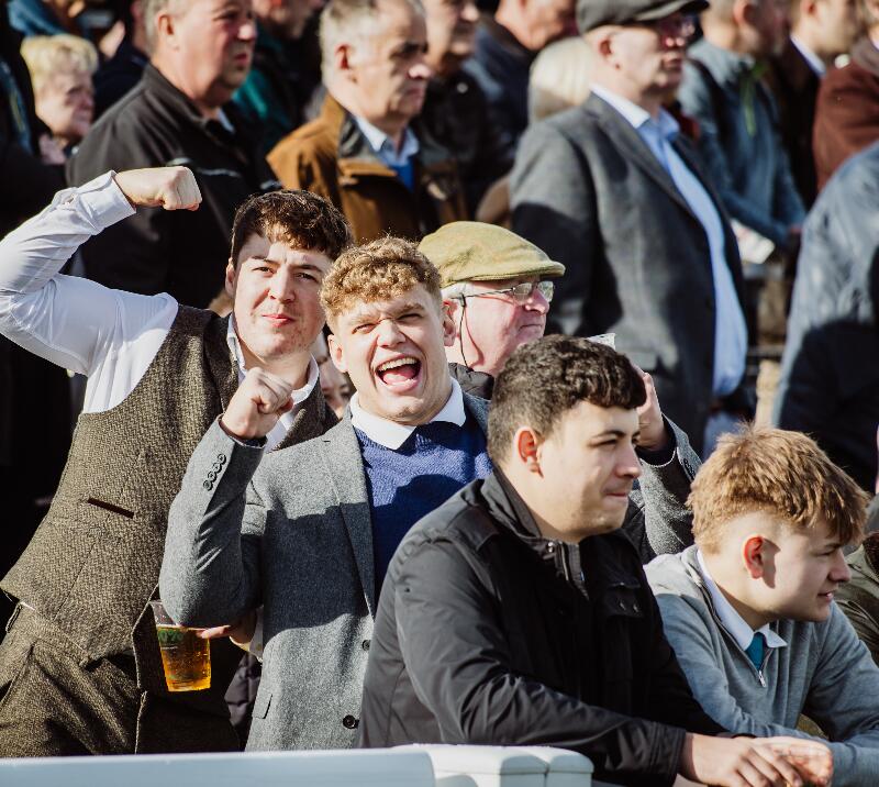 Group of lads watching a race.