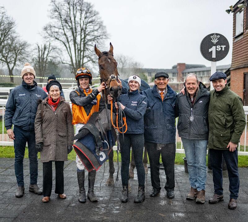 Owners and trainers gathered by winning horse.