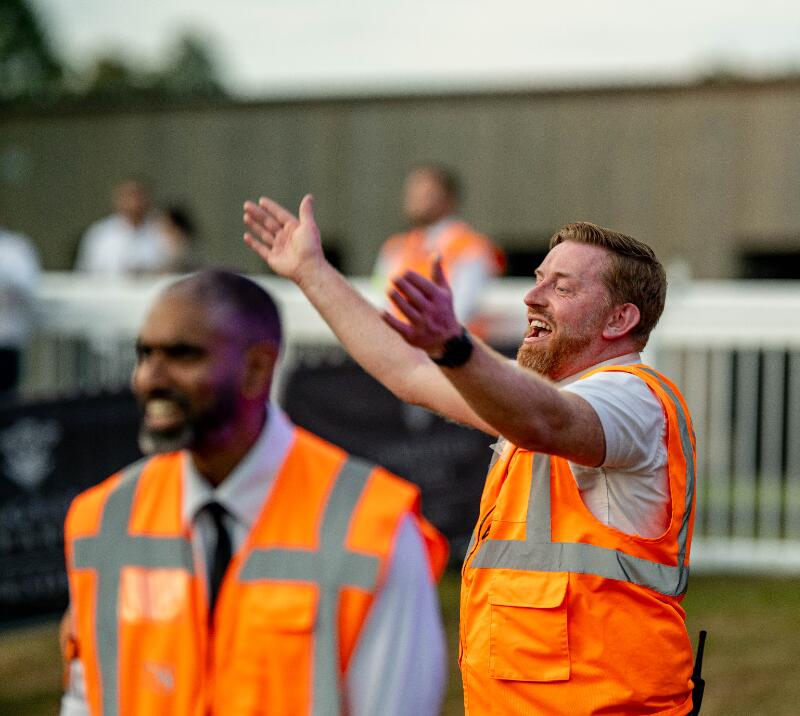 A steward happily welcomes visitors to Lingfield Park