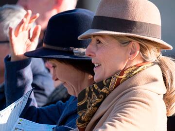 Woman dressed warmly for to enjoy a day at the races