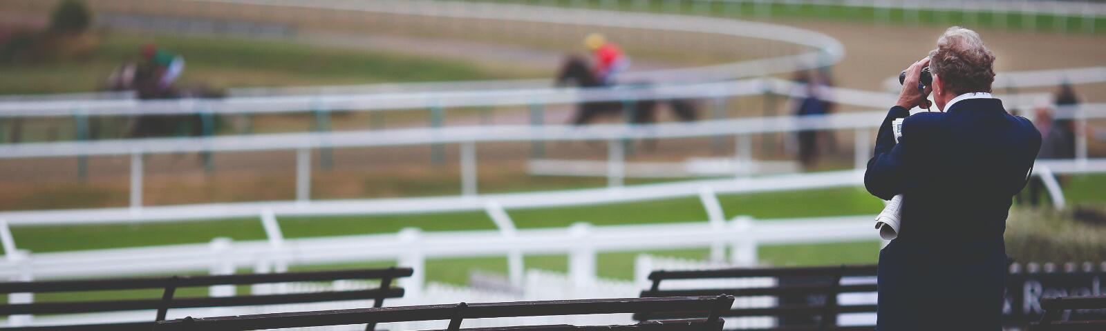 Horse owner watching racing at Lingfield Park Racecourse — premier facilities for owners and trainers in Surrey