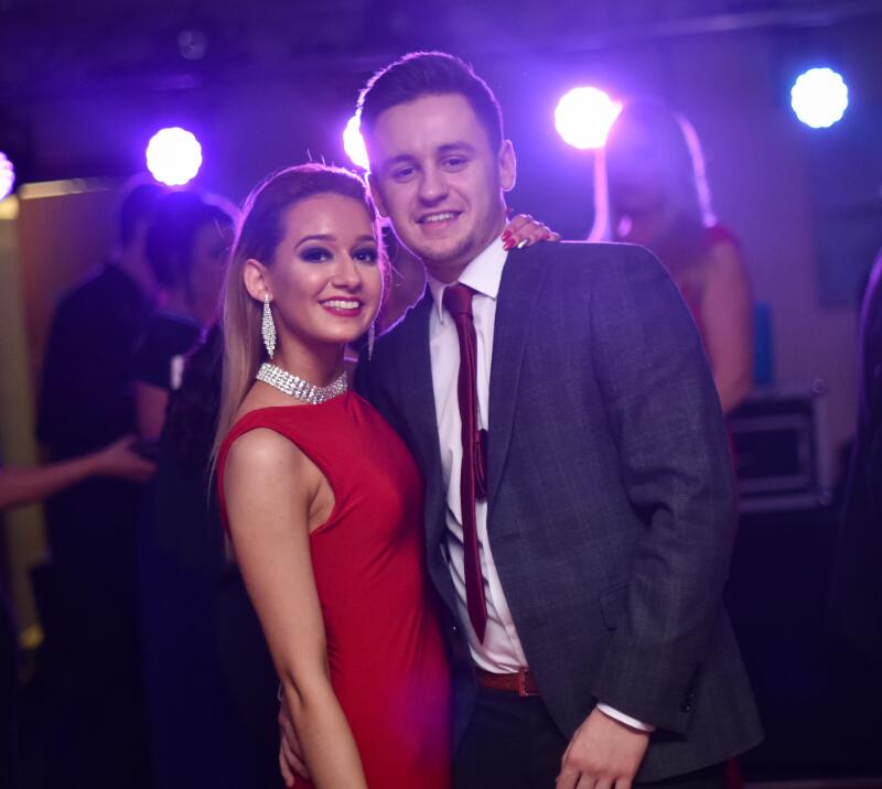 A well presented couple posing for a photo