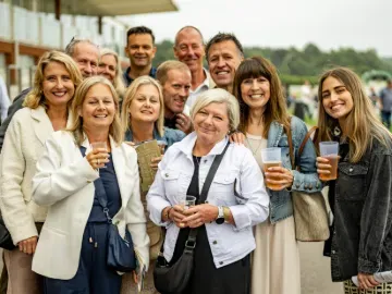 A group of smiling guests at Lingfield Park